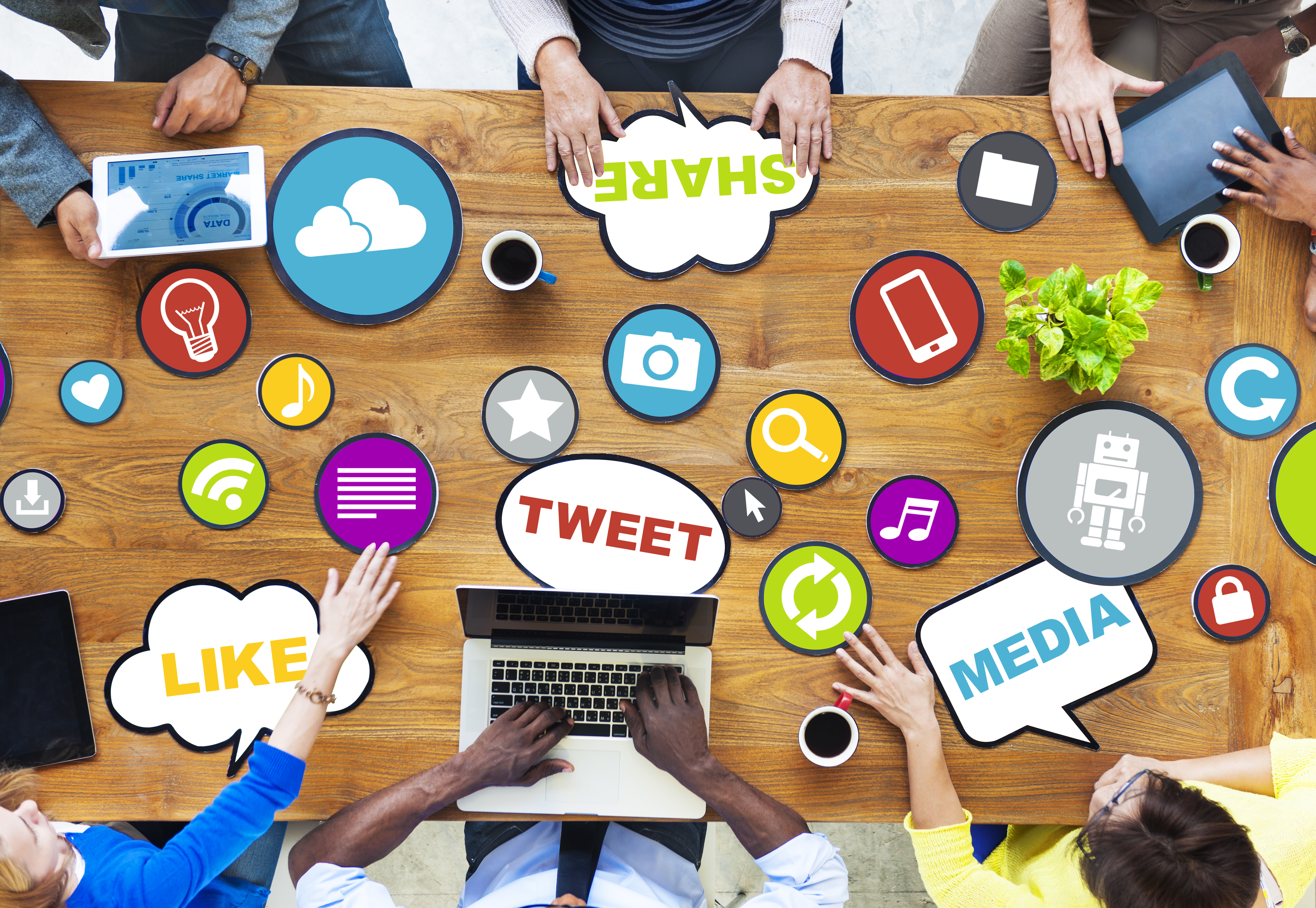 A desk with people discusing social media.